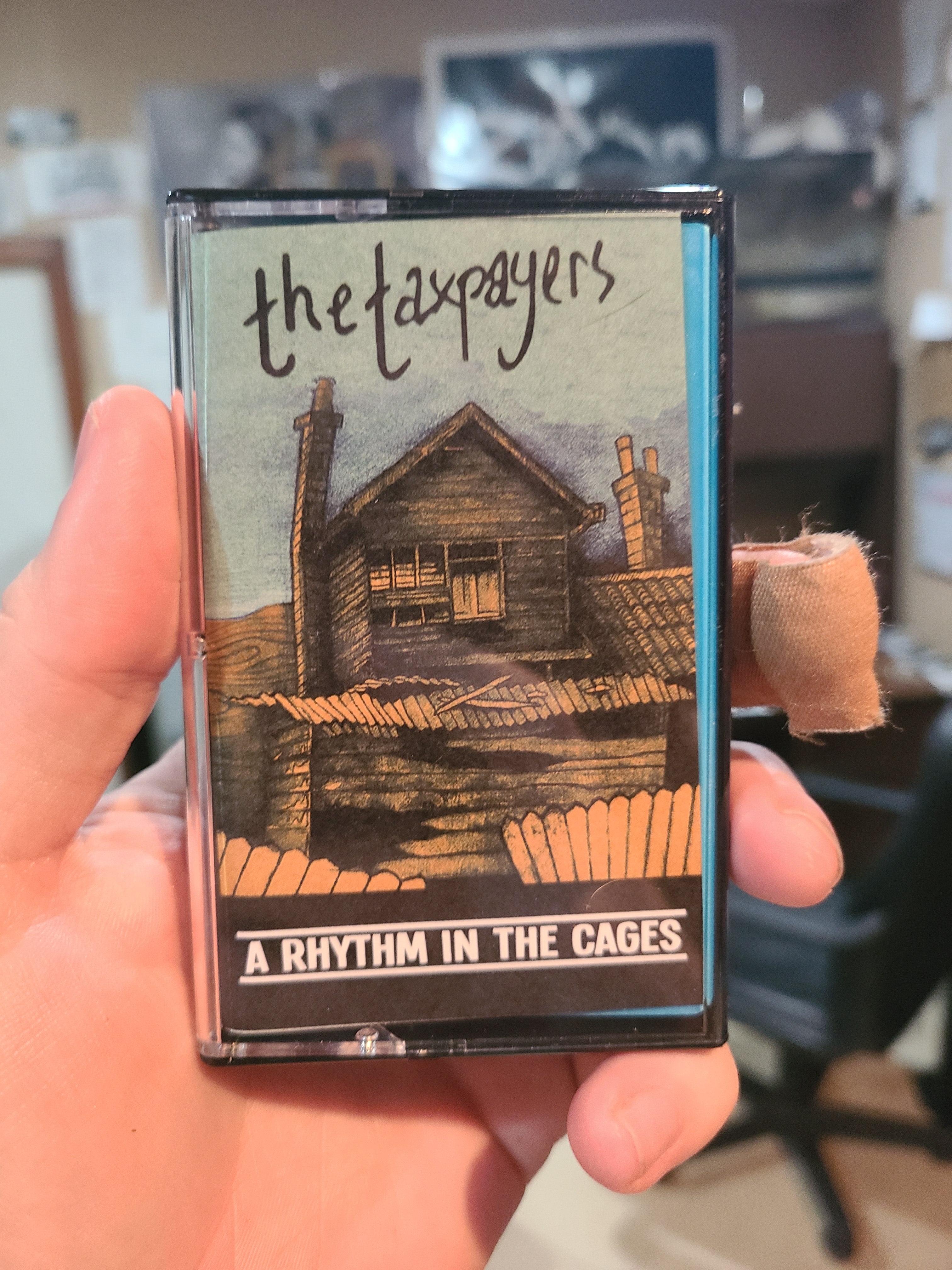 The Taxpayers - A Rhythm In The Cages - Cassette Tape Physical Media